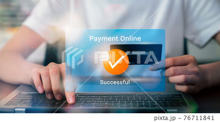 Woman using laptop and holding credit card with payment online successful screen. 76711841