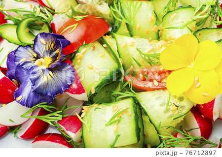 Spring vegetable salad with flowers,food background 76712897