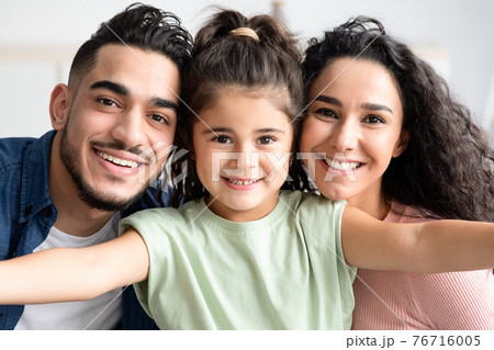Young Family Portrait. Cute Little Girl Taking Selfie With Her Arab Parents 76716005