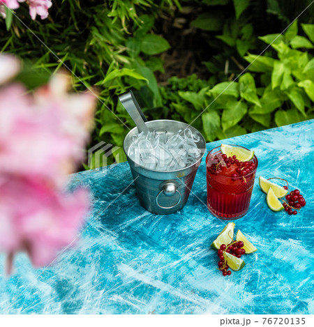 Lingonberry fruit with lime and ice in bucket Lingonberry fruit with lime and ice in bucket 76720135