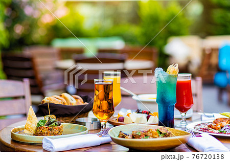 Tasty meals, cocktail, bread on the terrace restaurant table Tasty meals, cocktail, bread on the terrace restaurant table 76720138