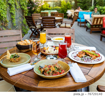 Tasty meals, cocktail, bread on the terrace restaurant table Tasty meals, cocktail, bread on the terrace restaurant table 76720140