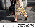 Detail of a fashionable outfit woman wearing colorful dress and summer shoes 76720279