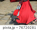 Detail of a fashionable outfit woman with red dress and red purse 76720281