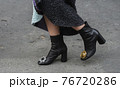 Detail of a fashionable outfit woman wearing black shoes 76720286