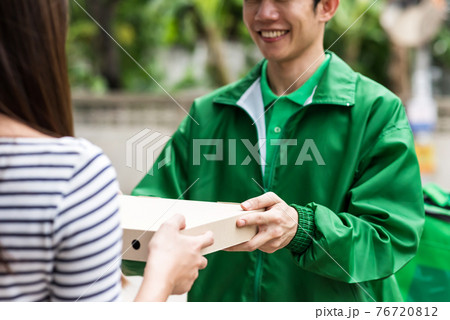 Pizza Delivery to customer with smiling face 76720812