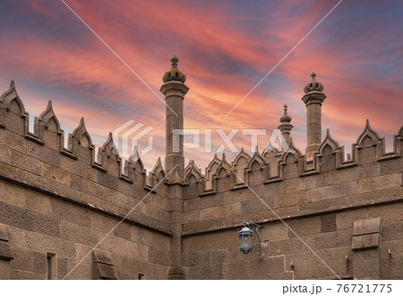 The walls and towers of the old palace on the background of beautiful pink sunset The walls and towers of the old palace on the background of beautiful pink sunset 76721775