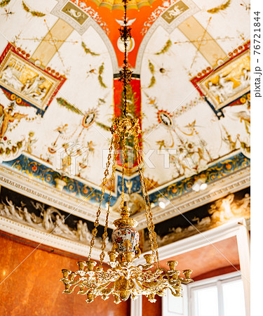 Antique Italian chandelier chandelier. Gold chandelier with candlesticks against the background of the painted ceiling. 76721844
