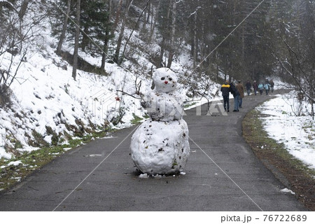 Snowman made of snow on the road in the national park. 76722689