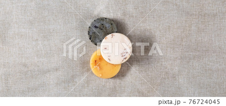 Three round natural handmade soaps on the cotton background.  76724045