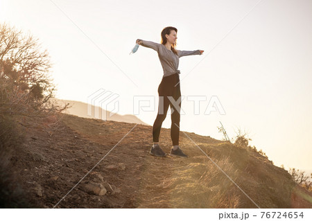 Woman took off her mask in mountains 76724654