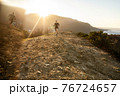 Running man on mountain and sun background 76724657