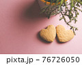 Two cookies in shape of a heart next to each other on a pink background. The concept of Valentine's Day. 76726050