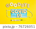 Words GOODBYE COVID 19 from wooden letters, syringe and facemask. Vaccination and the end of epidemic concept. 76726051