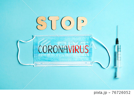 Words STOP CORONAVIRUS from wooden letters and letters on facemask and syringe. Vaccination and the end of epidemic concept. Words STOP CORONAVIRUS from wooden letters and letters on facemask and syringe. Vaccination and the end of epidemic concept. 76726052