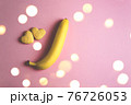 Two cookies in shape of a heart next to each other and banana on a pink background. The concept of Valentine's Day. 76726053