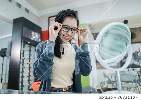 a beautiful woman wearing glasses that have been selected a beautiful woman wearing glasses that have been selected 76731107