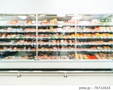 Defocused supermarket shelves with sausages 76732828