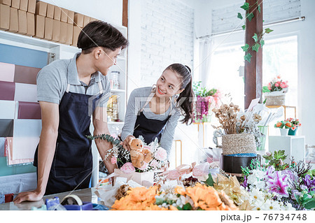 happy young man and female smiling talking while working together 76734748
