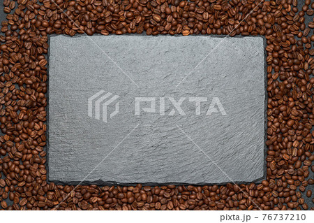 Background or texture made of roasted brown coffee beans and stone serving board Background or texture made of roasted brown coffee beans and stone serving board 76737210
