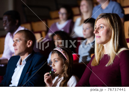 caucasian family sitting at premiere in cinema caucasian family sitting at premiere in cinema 76737441