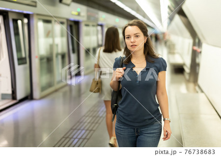 Woman waiting for train at underground station Woman waiting for train at underground station 76738683