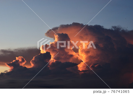 Cumulonimbus cloud formations on tropical sky with horizon is turning yellow at sunset , Nimbus moving , Purple and orange color clouds hunk at night , Thailand Cumulonimbus cloud formations on tropical sky with horizon is turning yellow at sunset , Nimbus moving , Purple and orange color clouds hunk at night , Thailand 76741065