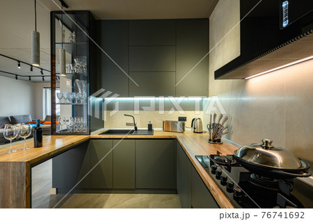 Modern large luxury dark gray kitchen closeup Modern large luxury dark gray kitchen closeup 76741692