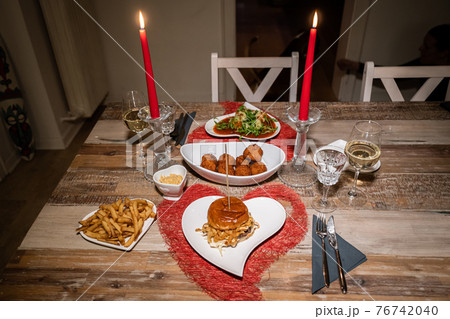 Valentines day dinner setting romantic love for two wooden table red heart shape candle light with Burger and Pasta Valentines day dinner setting romantic love for two wooden table red heart shape candle light with Burger and Pasta 76742040