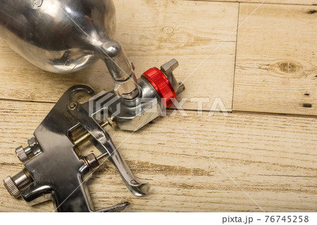 Paint spray on wooden floors Image of the painter's arm hand holding industrial size spray gun used for industrial painting and coating and isolated on background clipingpart Paint spray on wooden floors Image of the painter's arm hand holding industrial size spray gun used for industrial painting and coating and isolated on background clipingpart 76745258