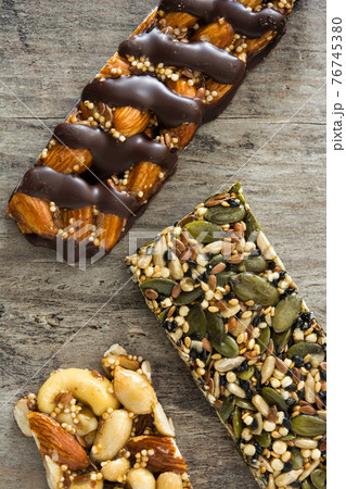 Muesli bars on wooden table 76745380