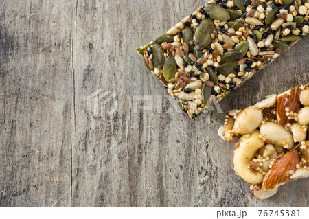 Muesli bars on wooden table 76745381