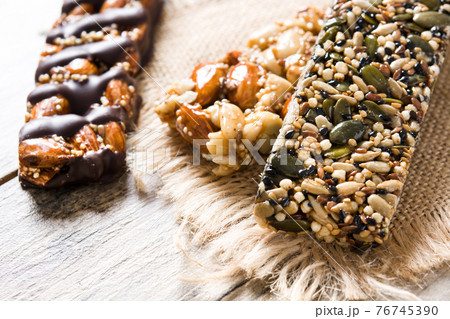 Muesli bars on wooden table 76745390