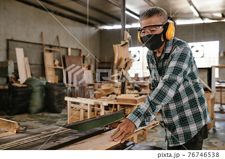 Senior man working with wood Senior man working with wood 76746538