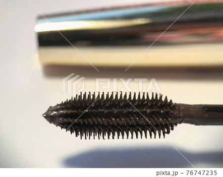 Close-up of mascara brush on white background. Beauty concept. Close-up of mascara brush on white background. Beauty concept. 76747235