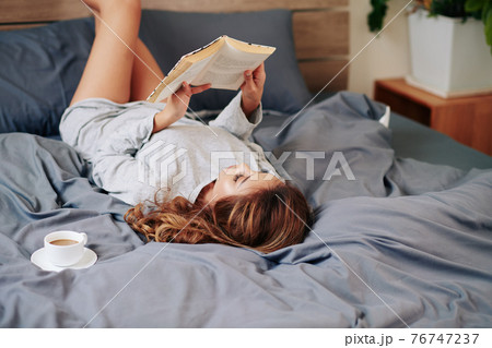 Woman enjoying good book 76747237