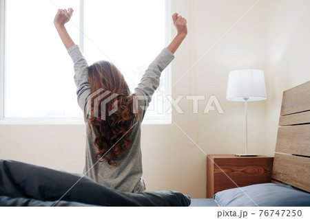 Woman stretching in the morning Woman stretching in the morning 76747250