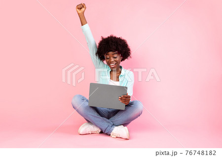 Joyful Black Lady With Laptop Shaking Fists On Pink Background Joyful Black Lady With Laptop Shaking Fists On Pink Background 76748182