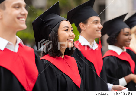 Multiracial group of graduates having graduation ceremony, closeup Multiracial group of graduates having graduation ceremony, closeup 76748598