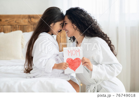Happy mom and little daughter celebrating Mothers Day together 76749018