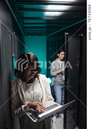 African American Woman Working in Data Center African American Woman Working in Data Center 76749066