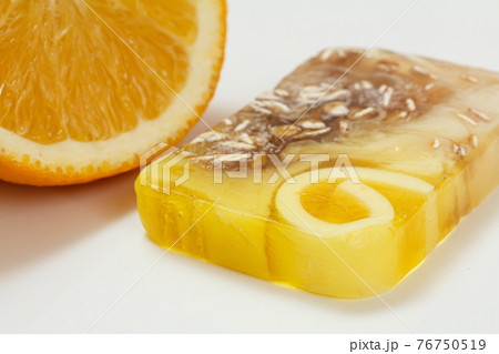 Cut orange and homemade soap on white background. 76750519