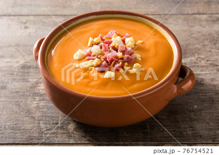 Typical Spanish salmorejo cream with ham and egg on wooden table Typical Spanish salmorejo cream with ham and egg on wooden table 76754521