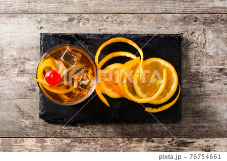 Old fashioned cocktail with orange and cherry Old fashioned cocktail with orange and cherry 76754661