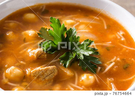 Harira soup in bowl on wooden table 76754664