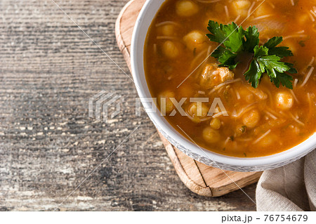 Harira soup in bowl on wooden table 76754679