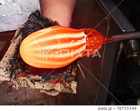 Art and craft worker shaping glass with mould from wet newspaper. Art and craft worker shaping glass with mould from wet newspaper. 76755549