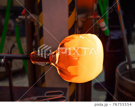 Handmade shaping of melted glass, selective focus 76755554