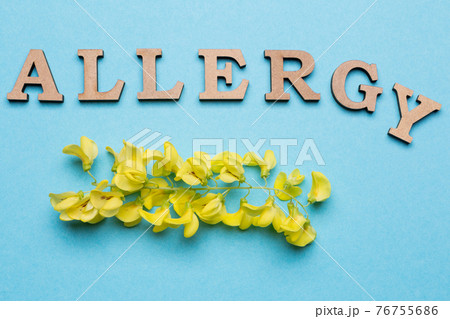 The inscription is alloted from letters on a blue background, below is a yellow inflorescence, a concept 76755686