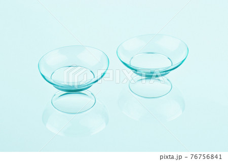Contact lenses on blue background. Contact lenses on blue background. 76756841